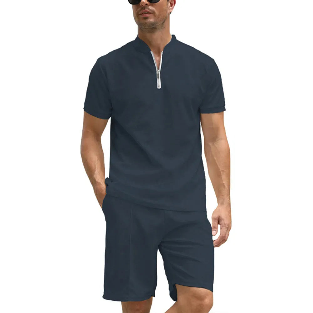 Men's solid colour polo shirt and trouser two-piece set in textured fabric.