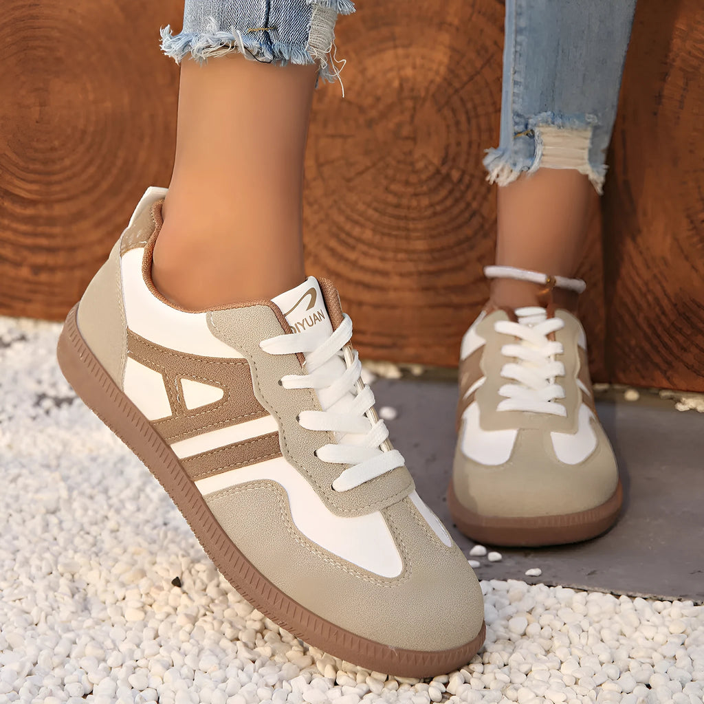 Retro lace-up women's jogging shoes in grey with a platform heel and cross strap detail.