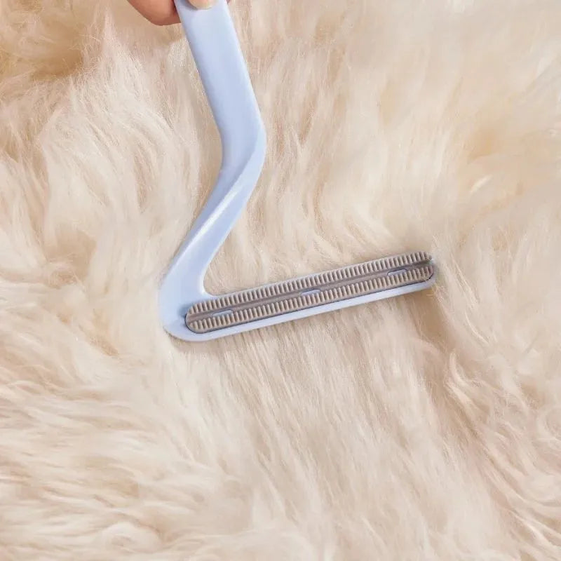 Double-sided pet hair removal comb in blue, white, and orange with sticky suction for cat and dog hair