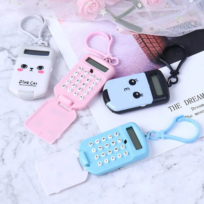 Cookie-shaped mini plastic calculator with key ring, 6.4cm x 3.6cm x 11.2cm, in pink, blue, grey, or black