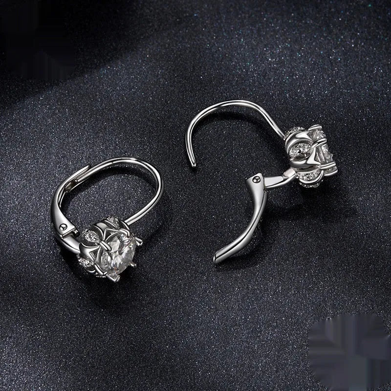 Sterling silver flower bud ear clips with white gold plating and a moissanite centre stone.