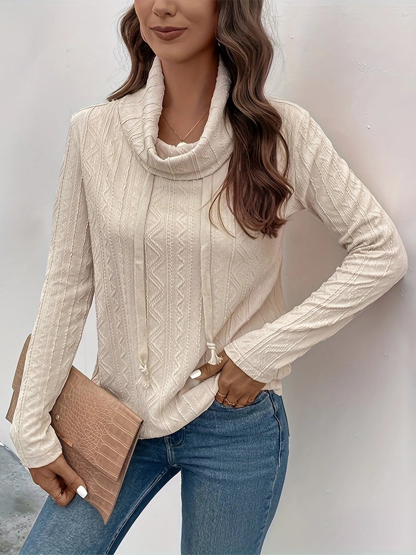 Apricot coloured long sleeve hooded pullover sweater on a hanger.