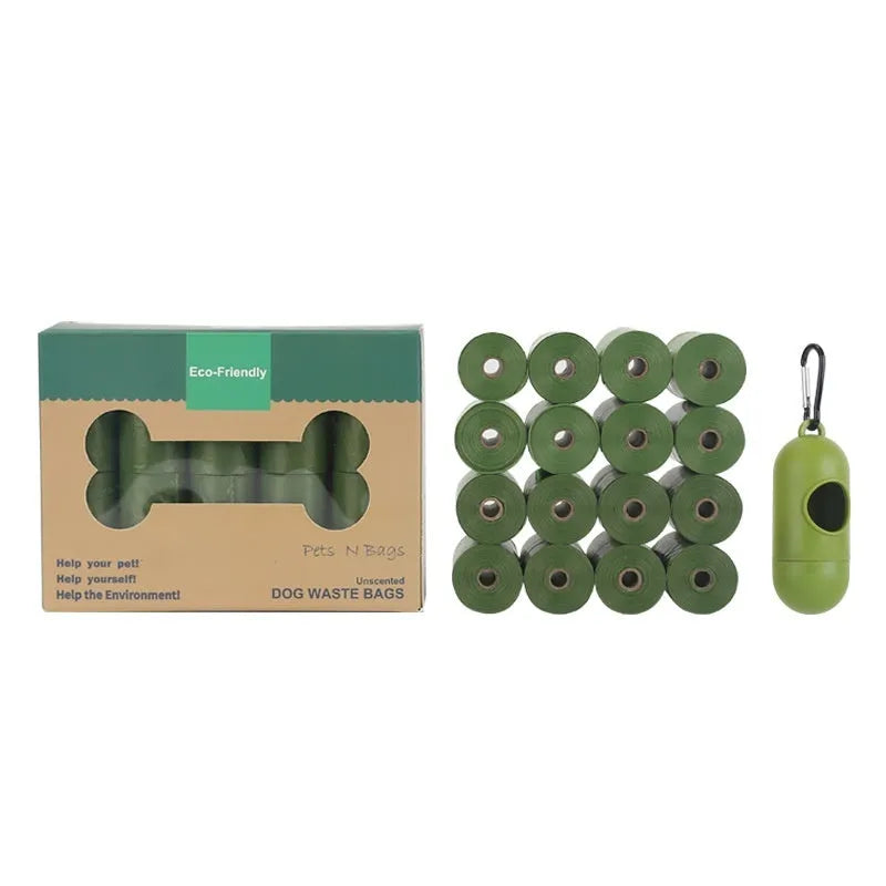 A roll of green EPI degradable pet waste bags next to a black dispenser on a grass background.