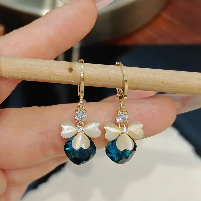 Women's blue crystal earrings with real gold plating bow shape and three-leaf flower motif