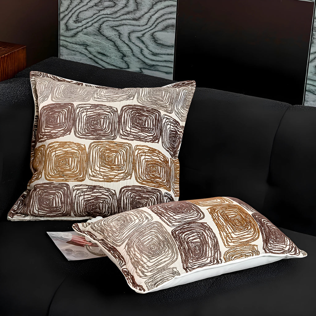 Cream and coffee coloured abstract coil pattern pillow cover shown in square and waist pillow sizes.