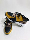 Women's casual suede wedge sneakers in leopard print with a low-cut design and plastic sole.