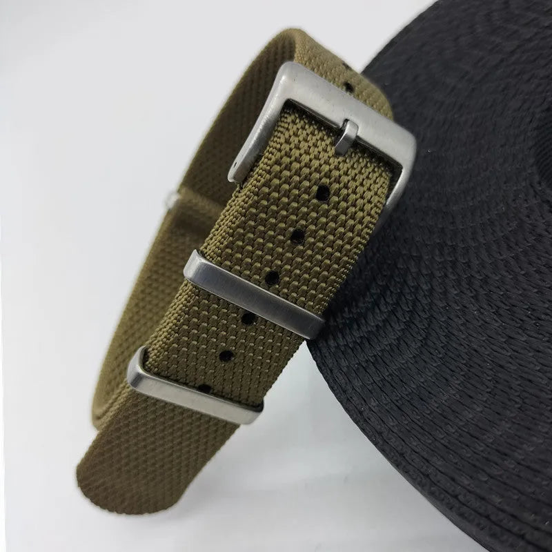 Nylon integrated watch strap in army green colour showing textile texture and buckle.