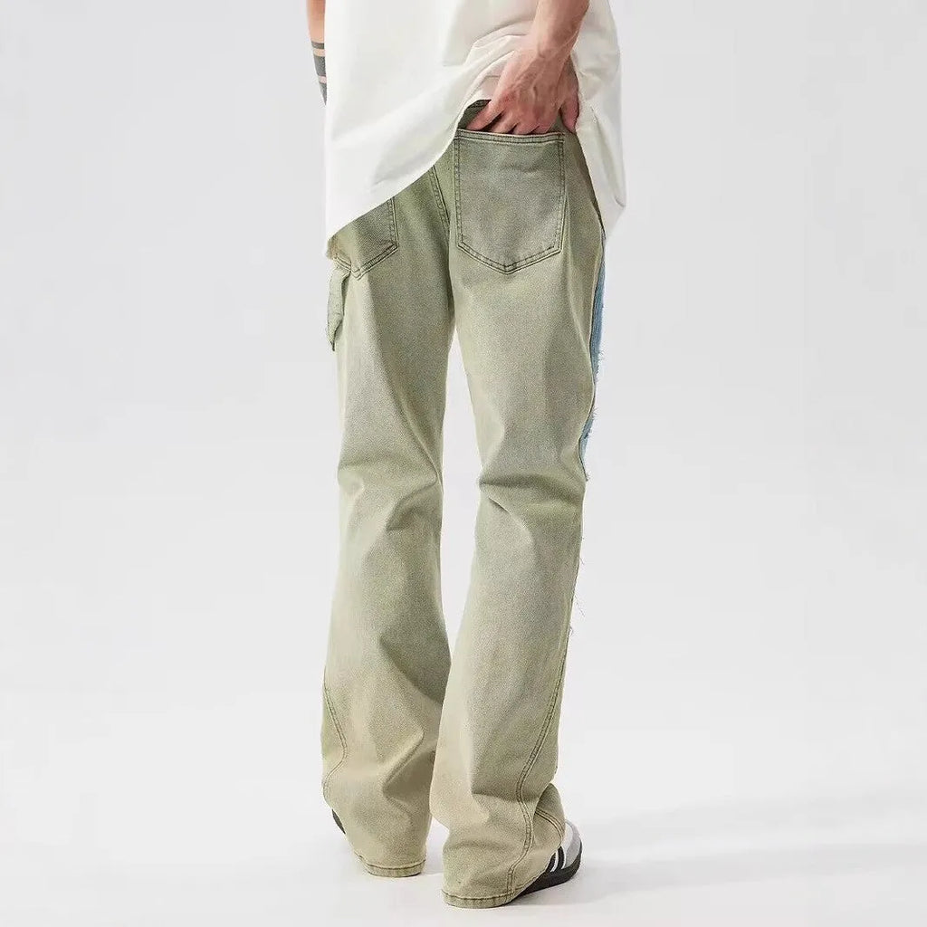Yellow and blue retro patchwork jeans with splash-ink distressed design and zip fly.