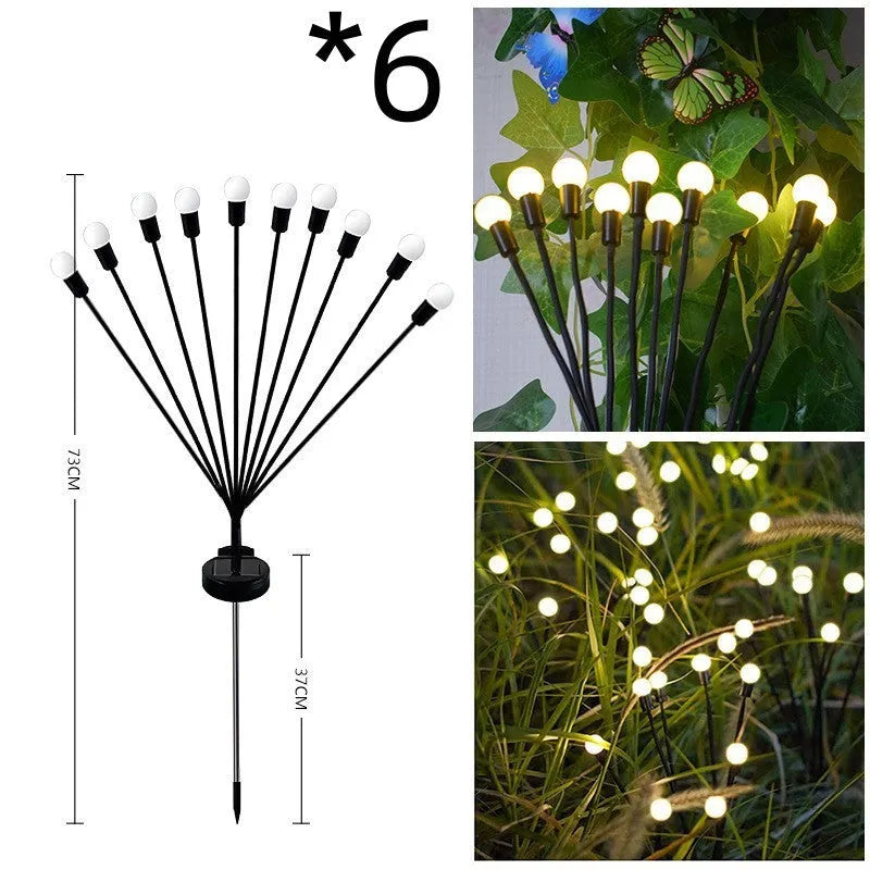 Solar-powered LED firefly garden spike light with multiple heads and a press-in ground plug on grass.