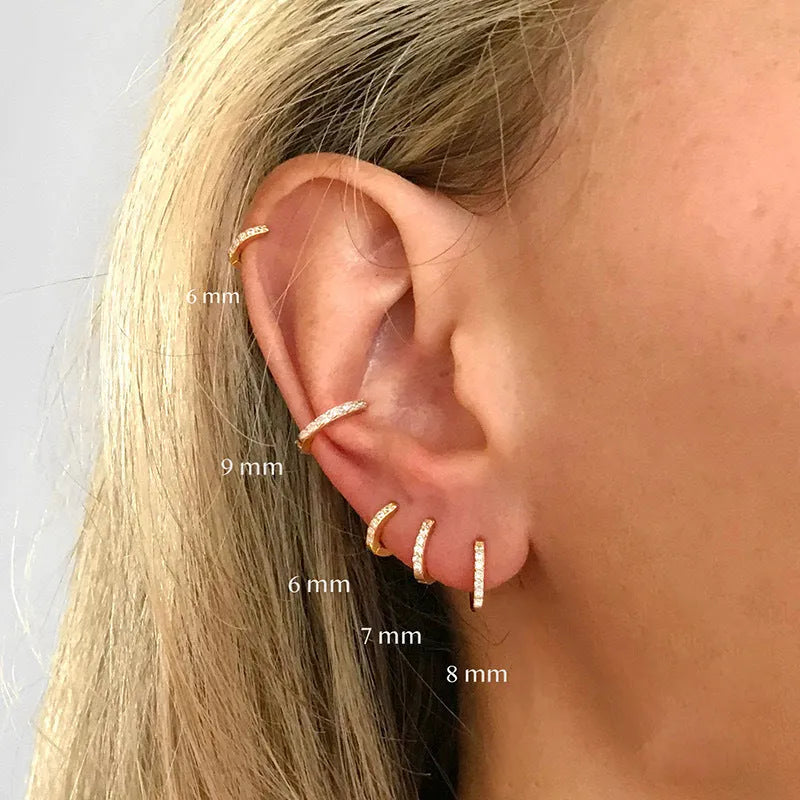 Gold, rose gold, and silver coloured perforated circle zircon stud earrings in various sizes from 5mm to 12mm.