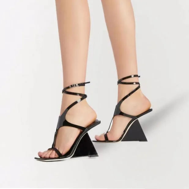 Women's black high heel sandals with a square toe and button ankle strap on a white background.