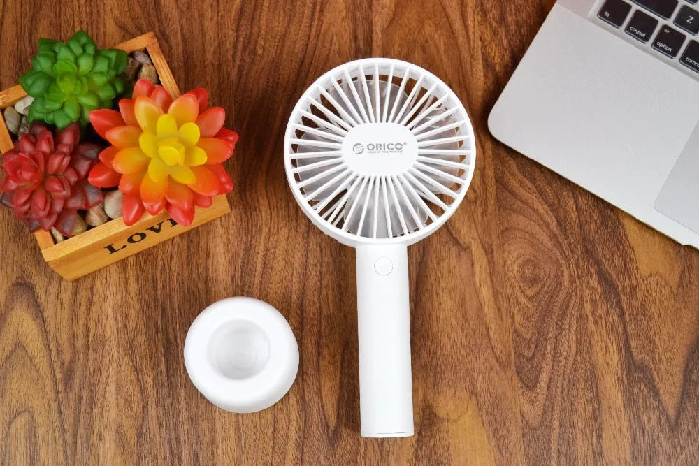 White ORICO FH1 portable USB rechargeable desk fan with three-speed buttons and compact handheld design.
