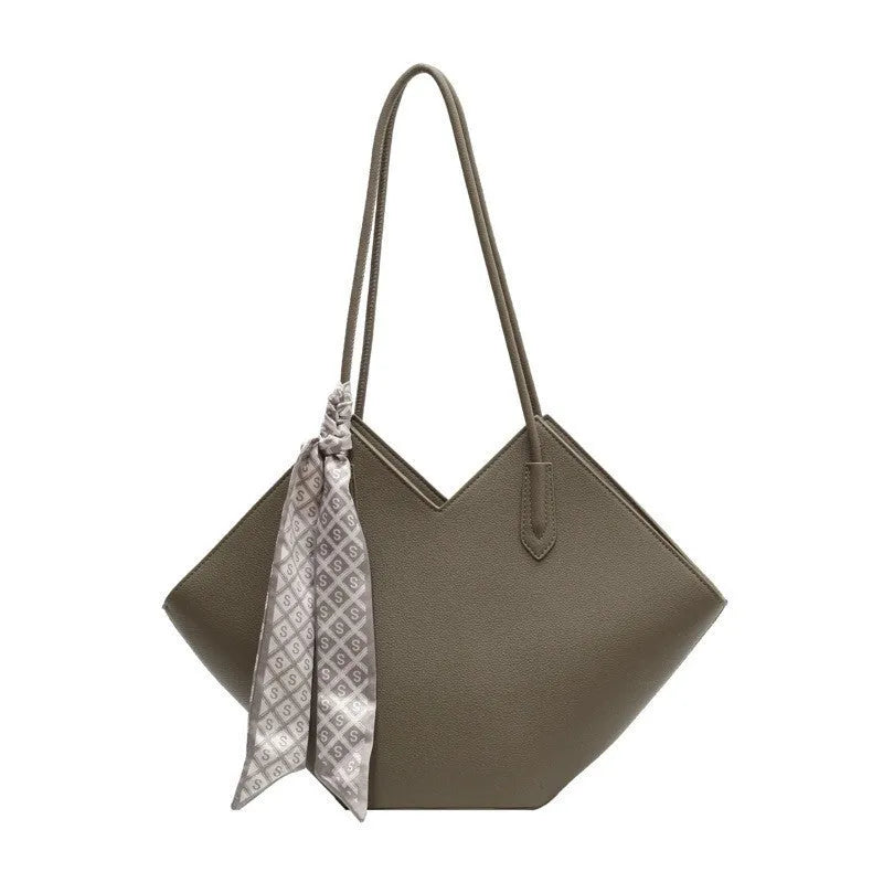Women's large beige PU leather shoulder bag with top handle showing structured horizontal square shape.