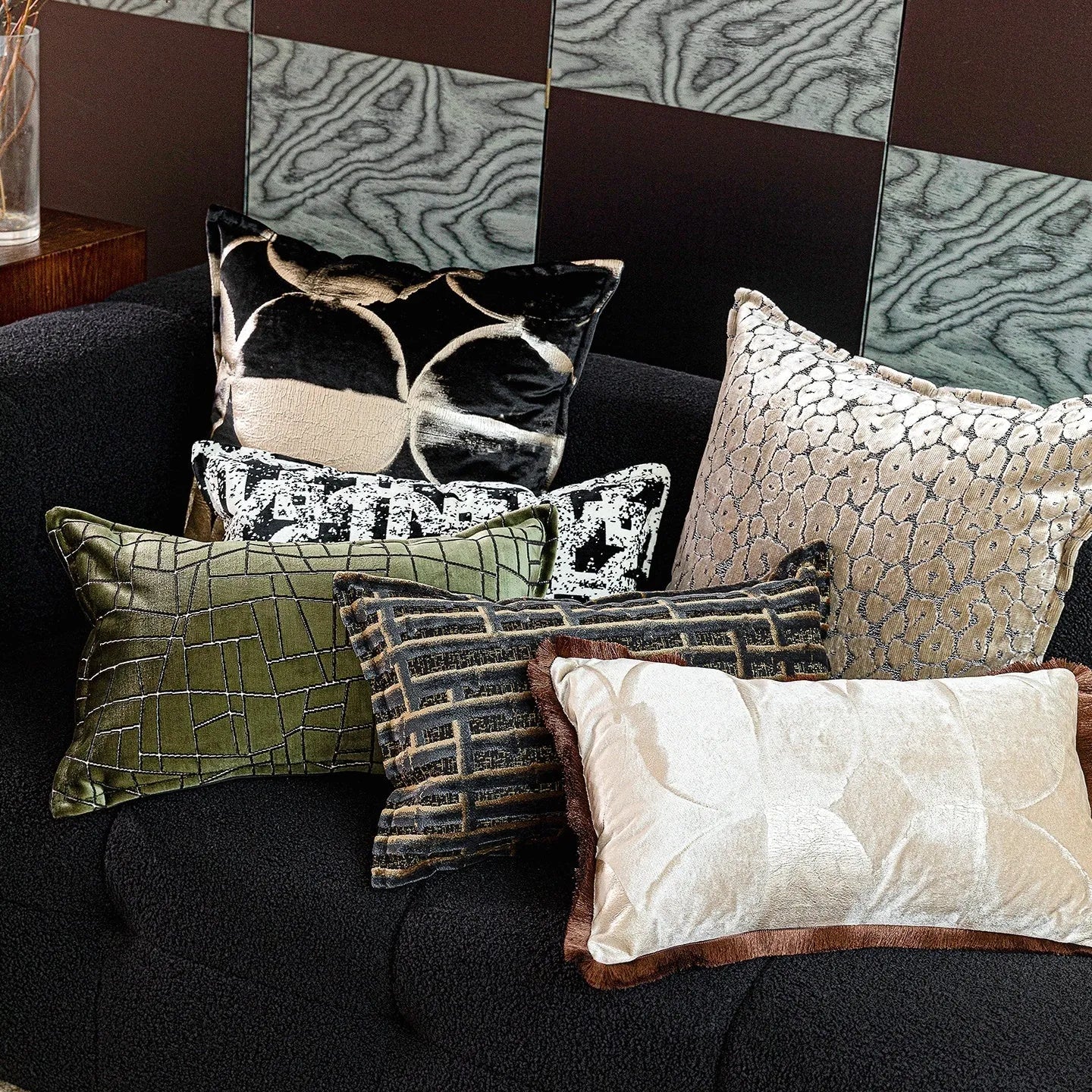Black and gold abstract pattern flannel cushion cover on a sofa