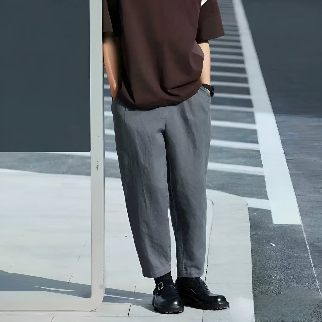 Men's loose fit straight leg casual trousers in beige with a drawstring waistband.