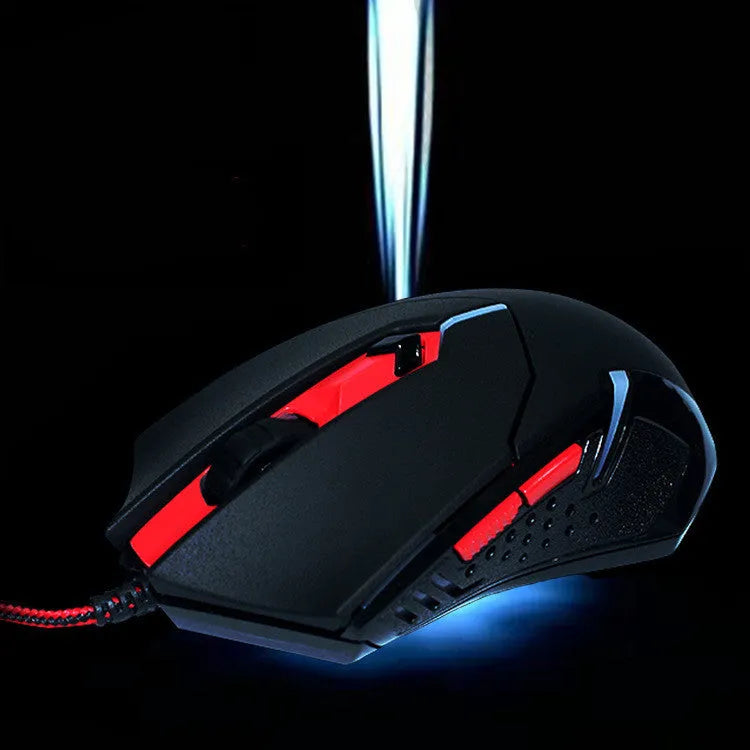 Black and red USB wired optical gaming mouse with six buttons on a desktop mat.