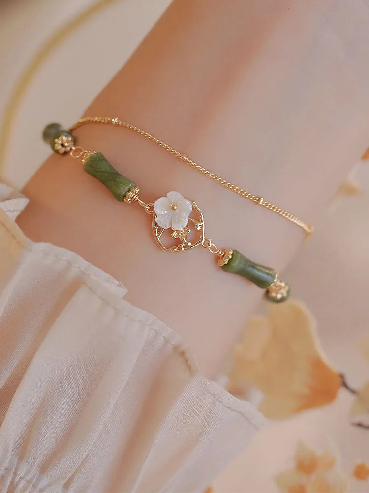 Handmade olivine bracelet with double layer Twin Bells of Ireland design on adjustable string cord