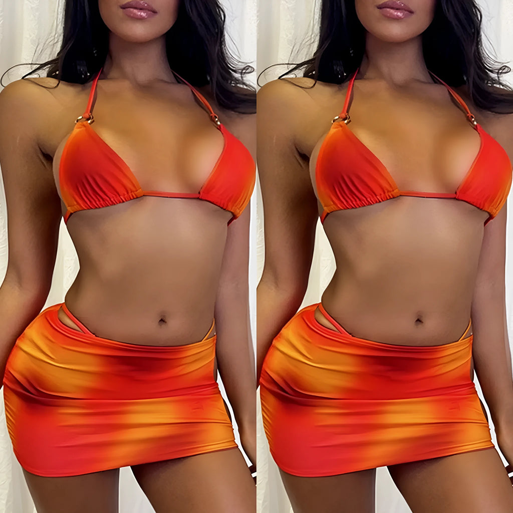 Tie-dye gradient pattern halter bikini top and briefs with matching skirt laid flat