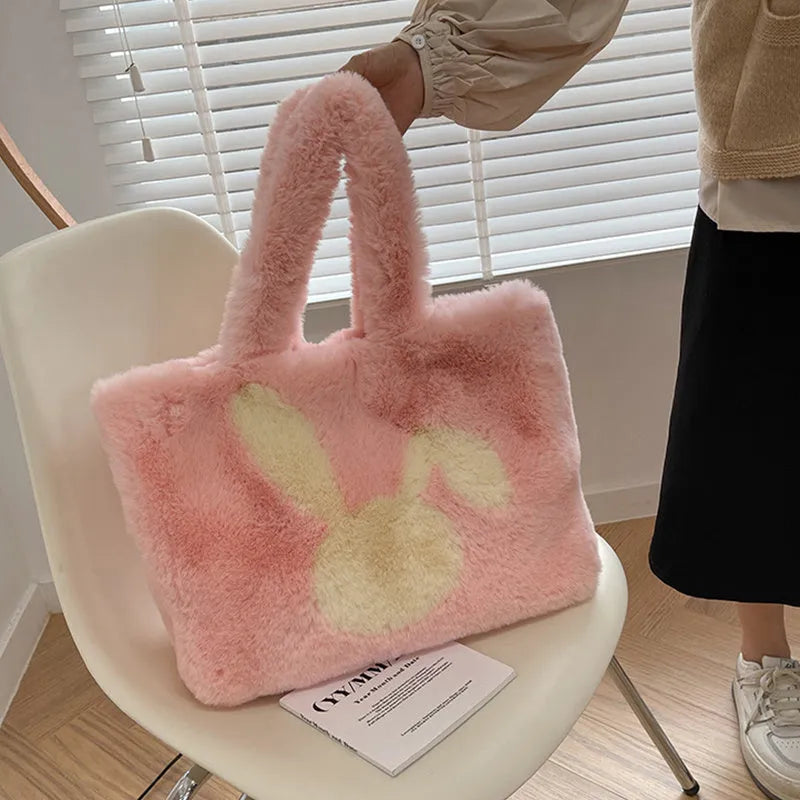 Cartoon rabbit ears plush shoulder tote bag in a solid colour on a model.
