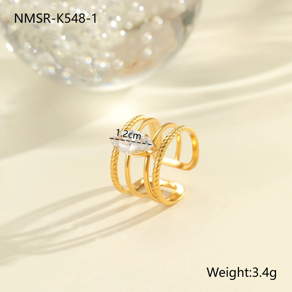 Gold electroplated adjustable ring with geometric zircon design on a stainless steel band.
