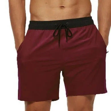 Men's blue fitness shorts with a drawstring waistband and a side zipper pocket.