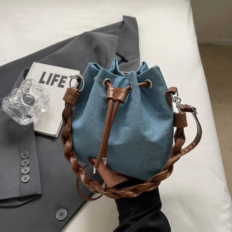 Blue one-shoulder cross body bucket bag with synthetic leather lining and sandwich pocket