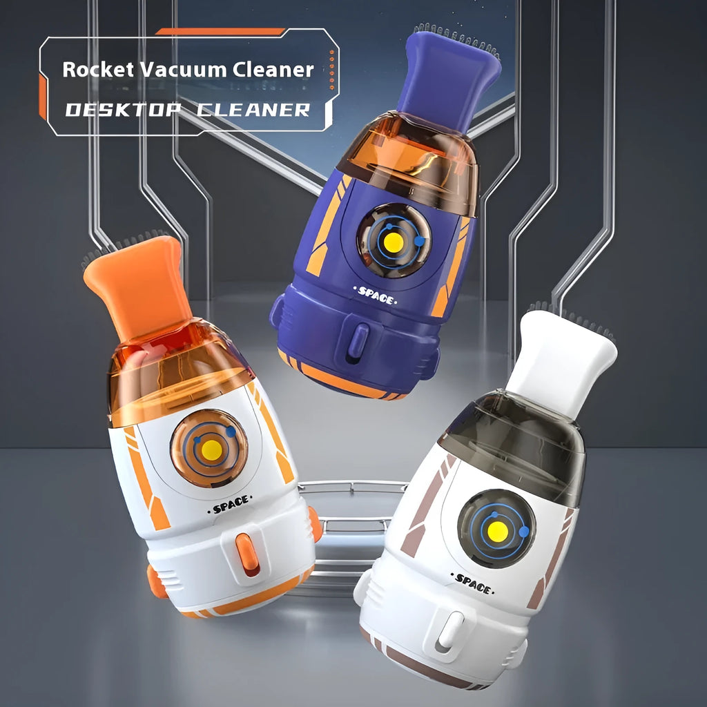 Handheld USB desktop vacuum cleaner in blue rocket design on a wooden desk next to a keyboard