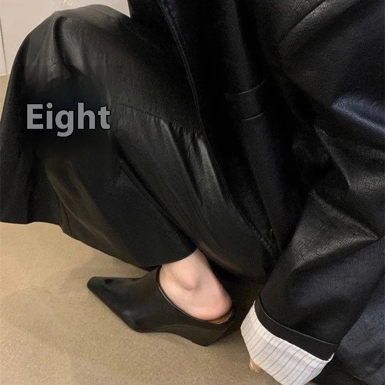 Women's black Wind Wedge closed toe half slippers with PU upper on a wooden floor.