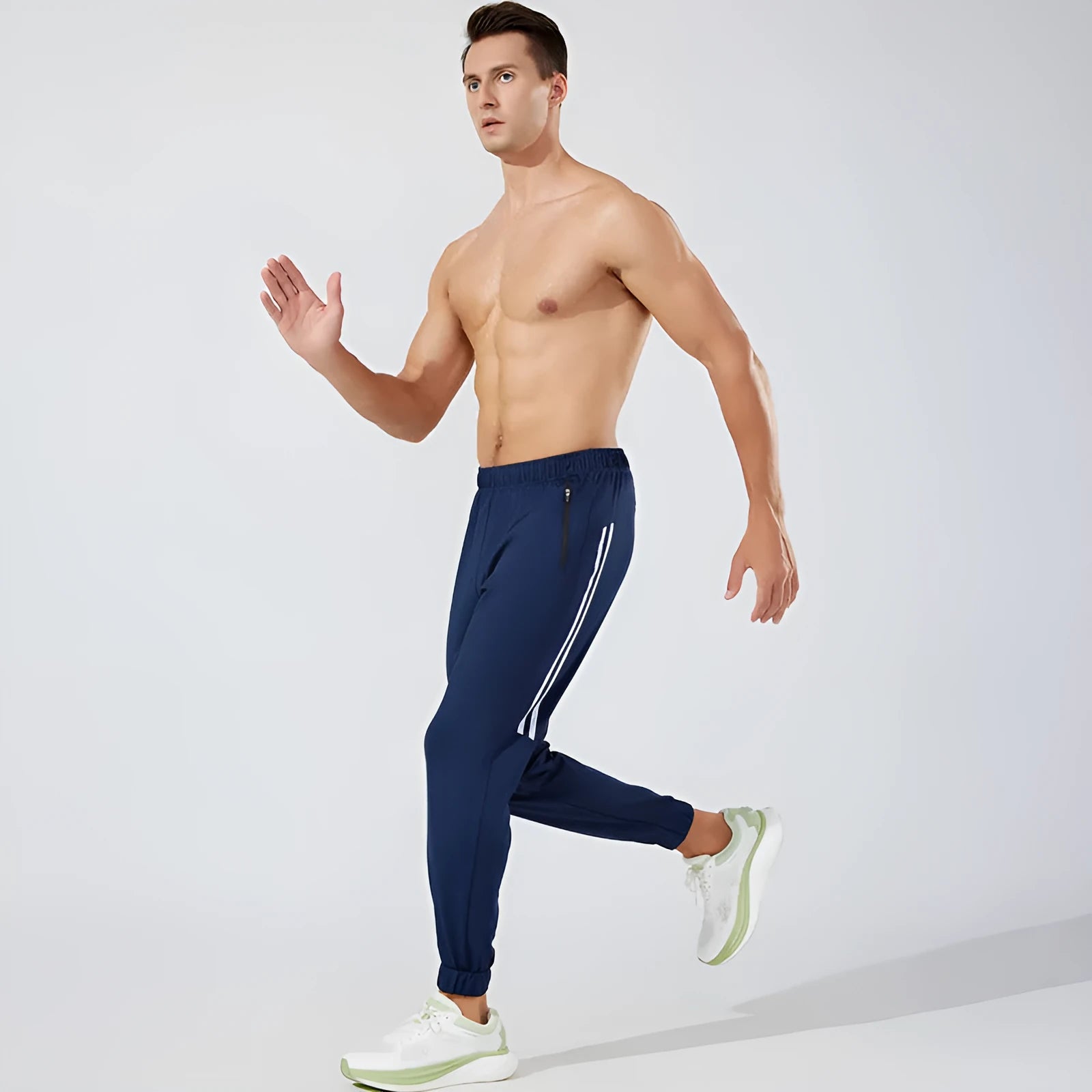Men's black breathable polyester running trousers with mid-waist fit on a plain background.