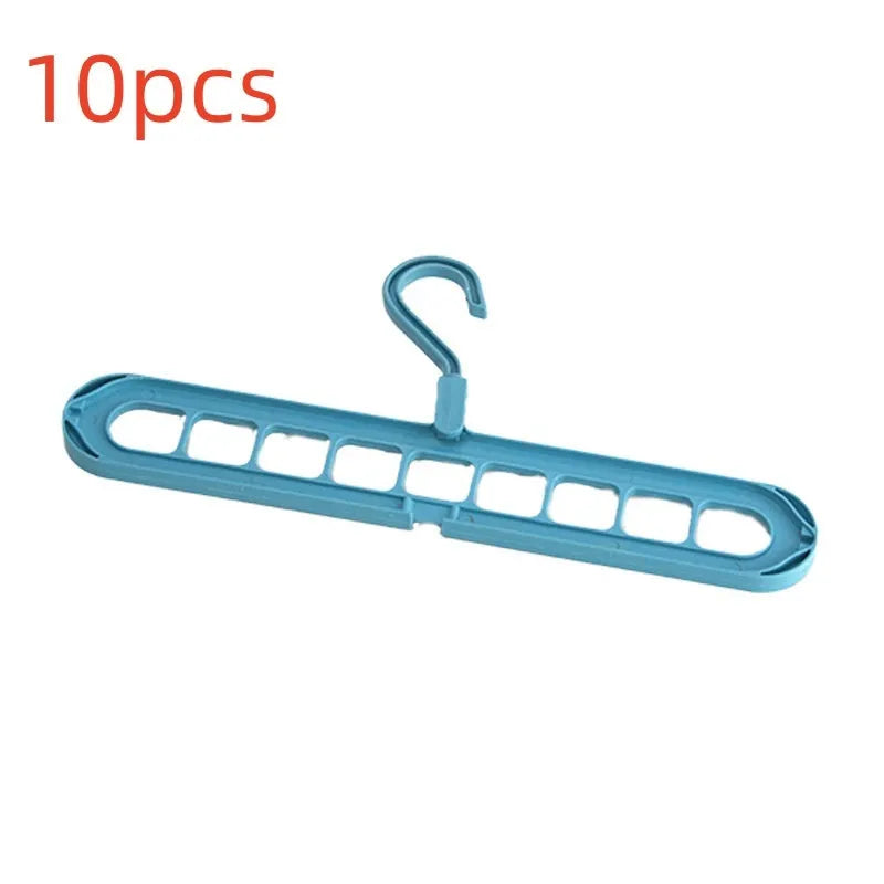 Green nine-hole plastic folding hanger for trousers and skirts showing multiple garment hanging points