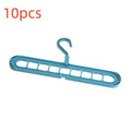 Green nine-hole plastic folding hanger for trousers and skirts showing multiple garment hanging points