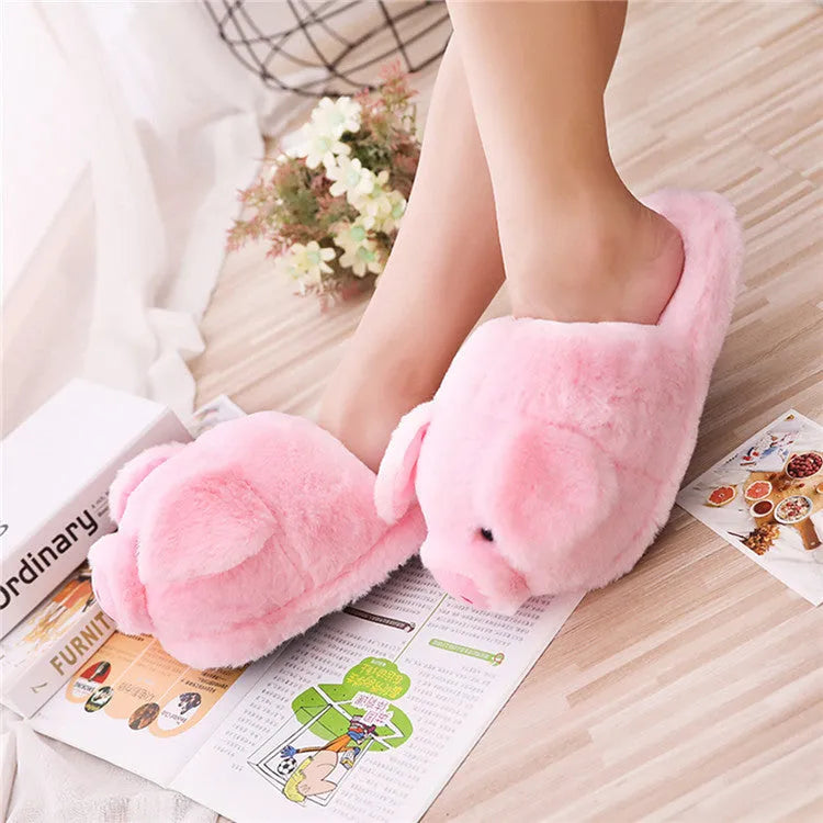 Pink pig-shaped plush floor slippers for indoor use.