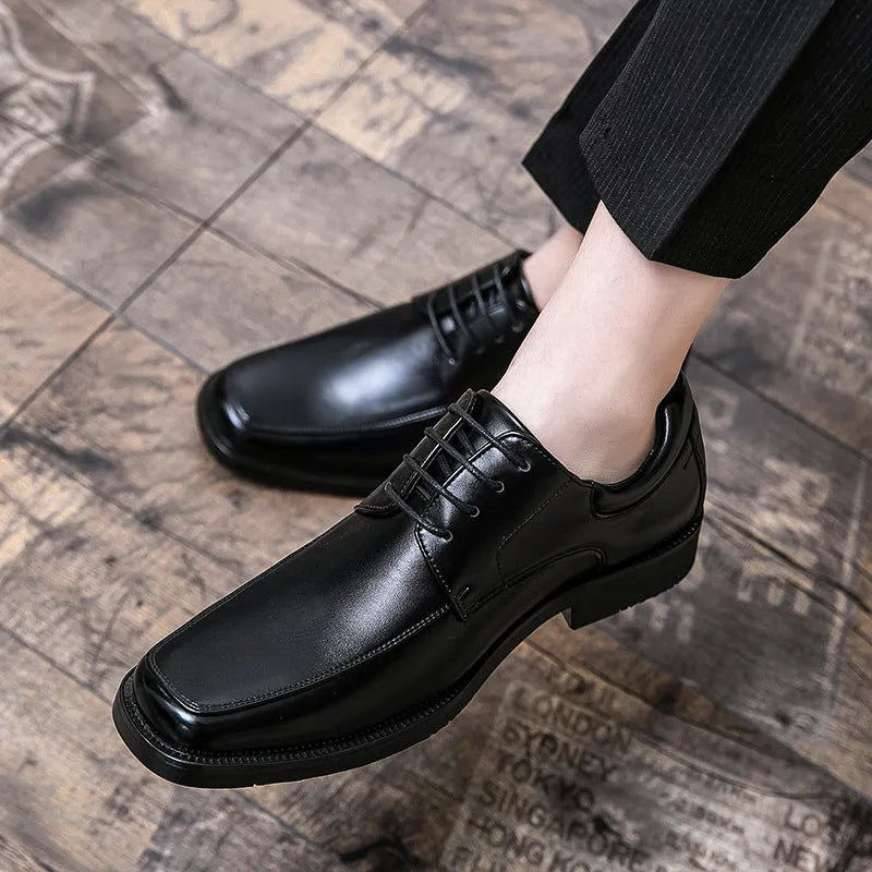 Men's black square toe low-top business casual shoes with a rubber sole.