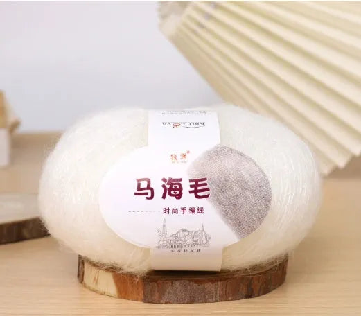 Ball of mohair yarn for DIY scarf knitting in one of 34 colours, including white, pink, blue, and green.
