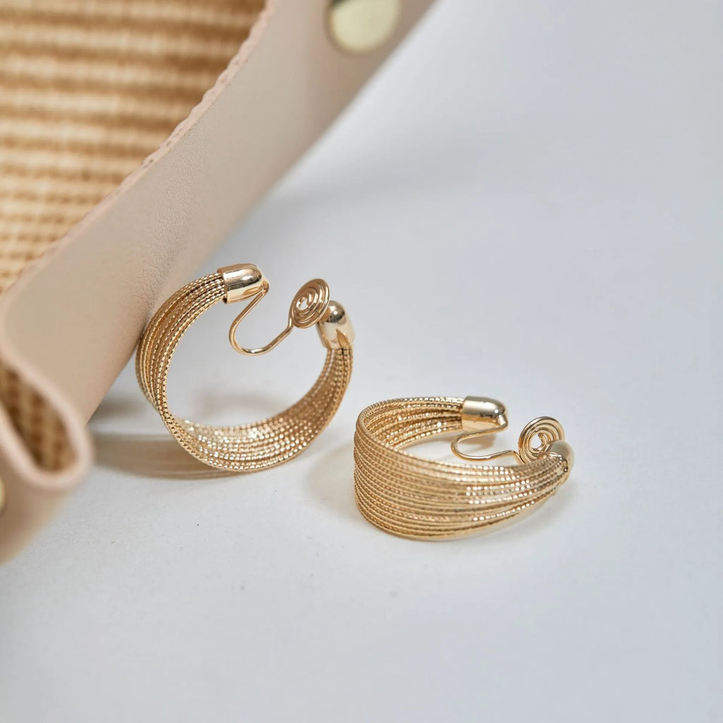 Copper geometric multi-layer bracelet earrings with electroplated silver and gold finish showing stud and clip pieces
