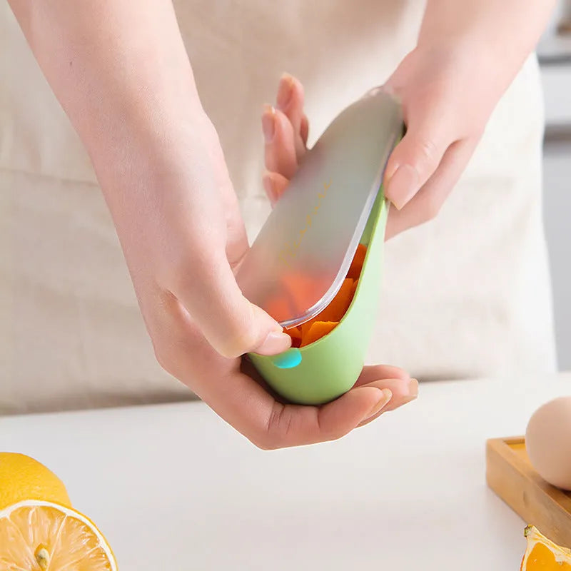 Green kitchen peeler with a stainless steel blade stored inside its transparent plastic tube.