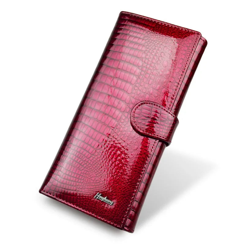 Red women's leather coin purse with a crocodile pattern texture and pigskin lining.