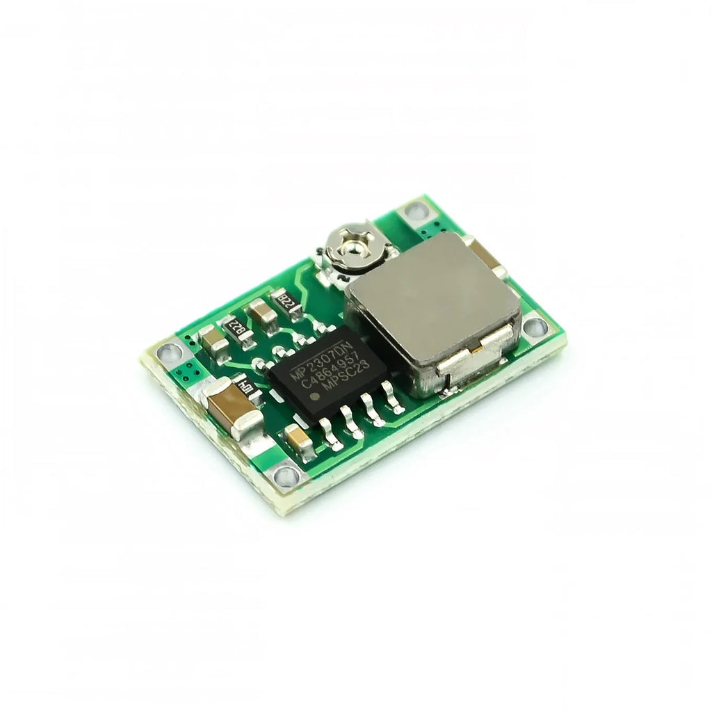 Mini-360 green DC-DC buck converter step-down power module on white background
