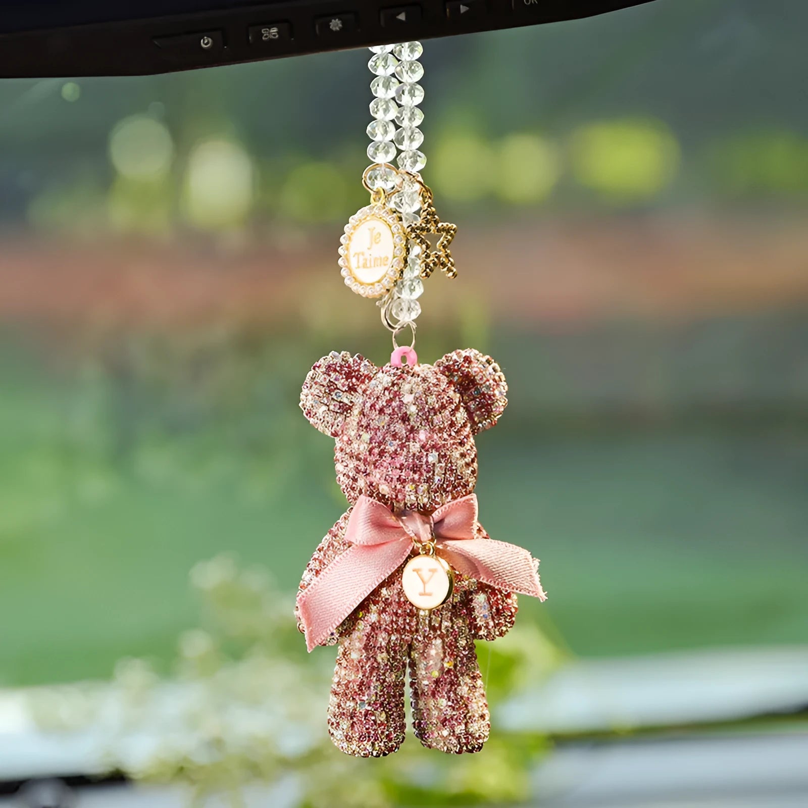 Black violent bear car mirror pendant with embedded crystal rhinestones on a white background.