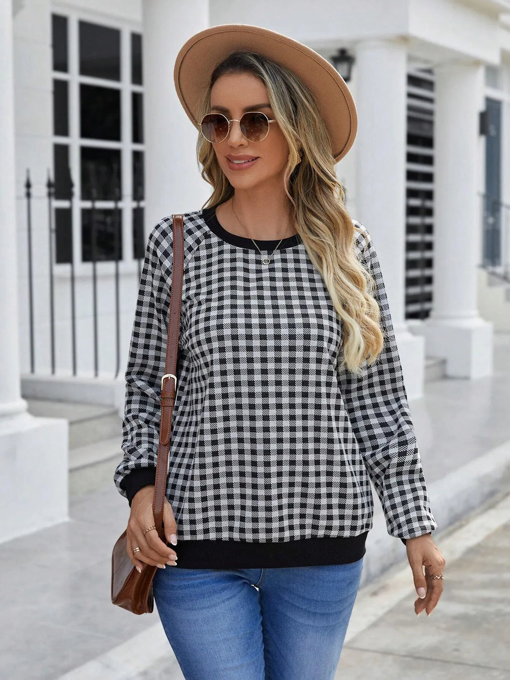 Black long sleeve pullover sweater with a classic plaid stripe print pattern.