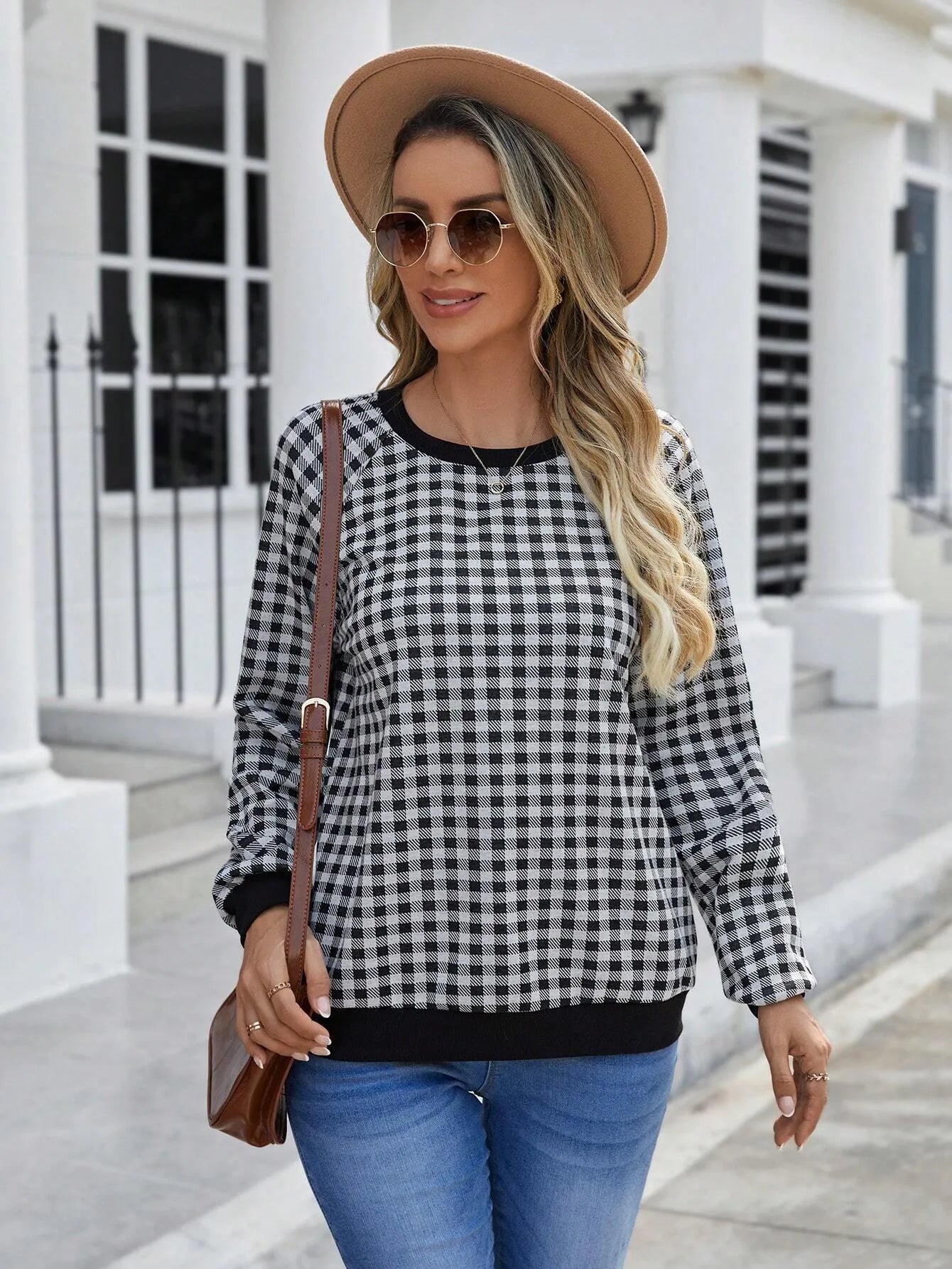 Black long sleeve pullover sweater with a classic plaid stripe print pattern.