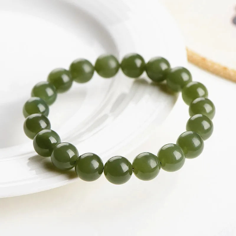 Polished Hetian jade ball bracelet on wrist, showing ice-like clear beads in available 4mm, 6mm, 8mm, and 10mm sizes.
