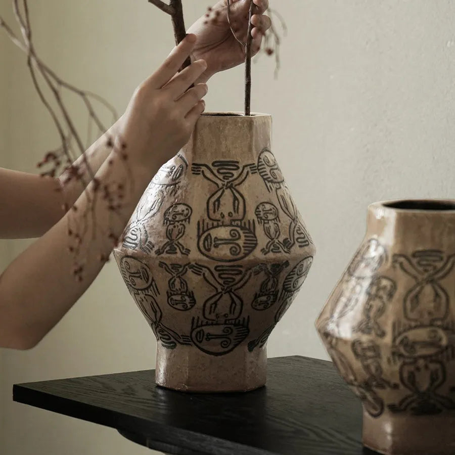 Hand-painted cylindrical ceramic vase with vintage carved tribal totem patterns in high or low style.
