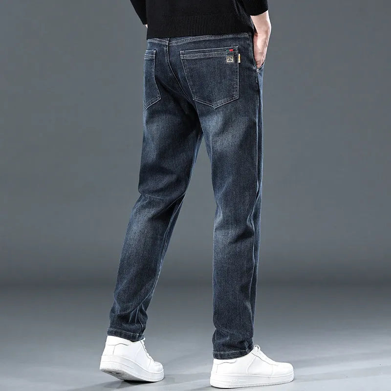 Man wearing blue-grey slim straight loose fit casual trousers with a micro-elastic waist.