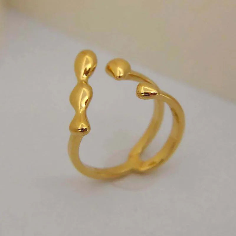 Brass spherical ring for women in gold or silver colour on a circular band.