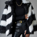Women's mid-length coat in contrasting colours with a faux fur collar.