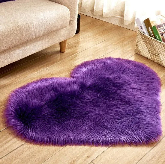 Heart-shaped plush carpet in multiple colours showing wool-like texture with 5-6 cm pile length
