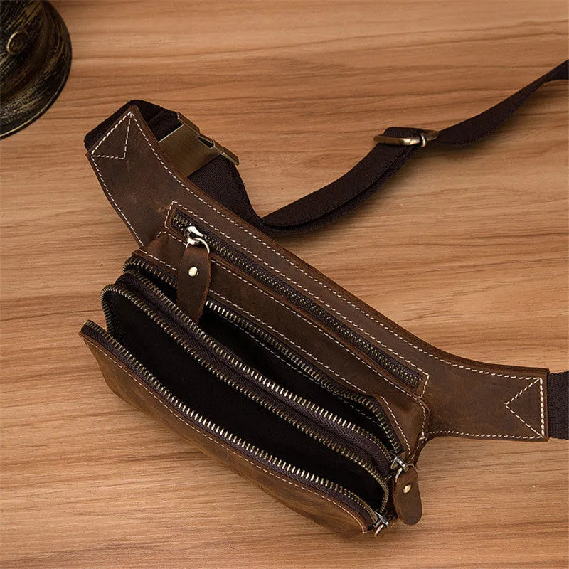 Brown top layer cowhide men's waist bag with pull cord closure, shown with phone compartment open.