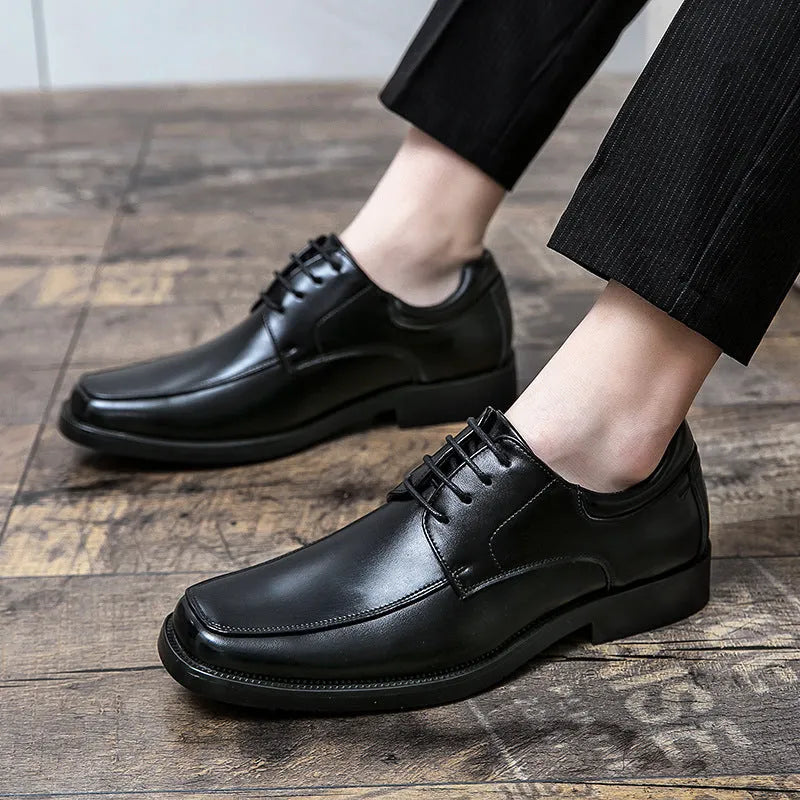 Men's black square toe low-top business casual shoes with a rubber sole.