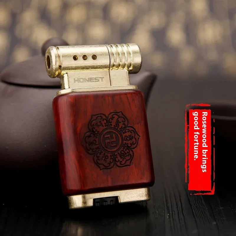 A decorative gas lighter with a carved wooden handle combining black wood, rosewood symbols, and a red wood tube accent.